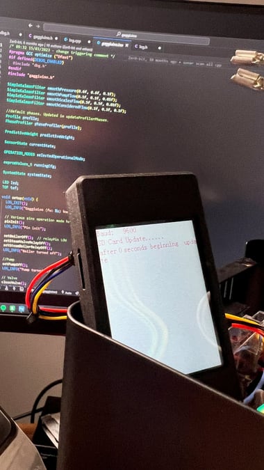 The Gaggiuino firmware source open in an editor, next to the Nextion display showing an SD card update in progress.
