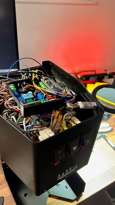 The finished electronics housing installed inside the Gaggia's shell, with the machine's original power, brew, and steam switches visible on the front panel.