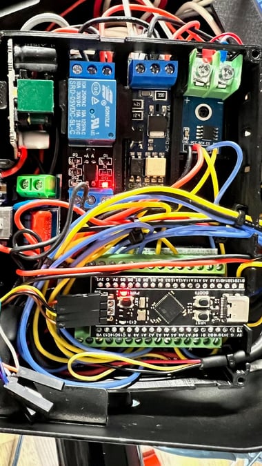 A tangle of wiring connecting a relay module, an AC dimmer module, and a Blackpill microcontroller, all mounted in a 3D-printed housing.