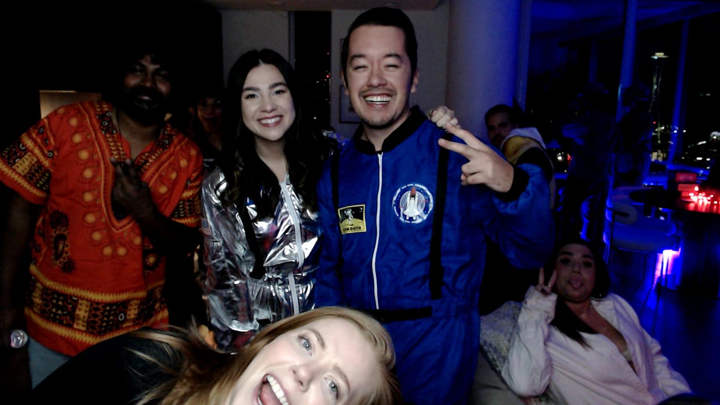 Guests posing at the photo booth during our 2023 Halloween party.