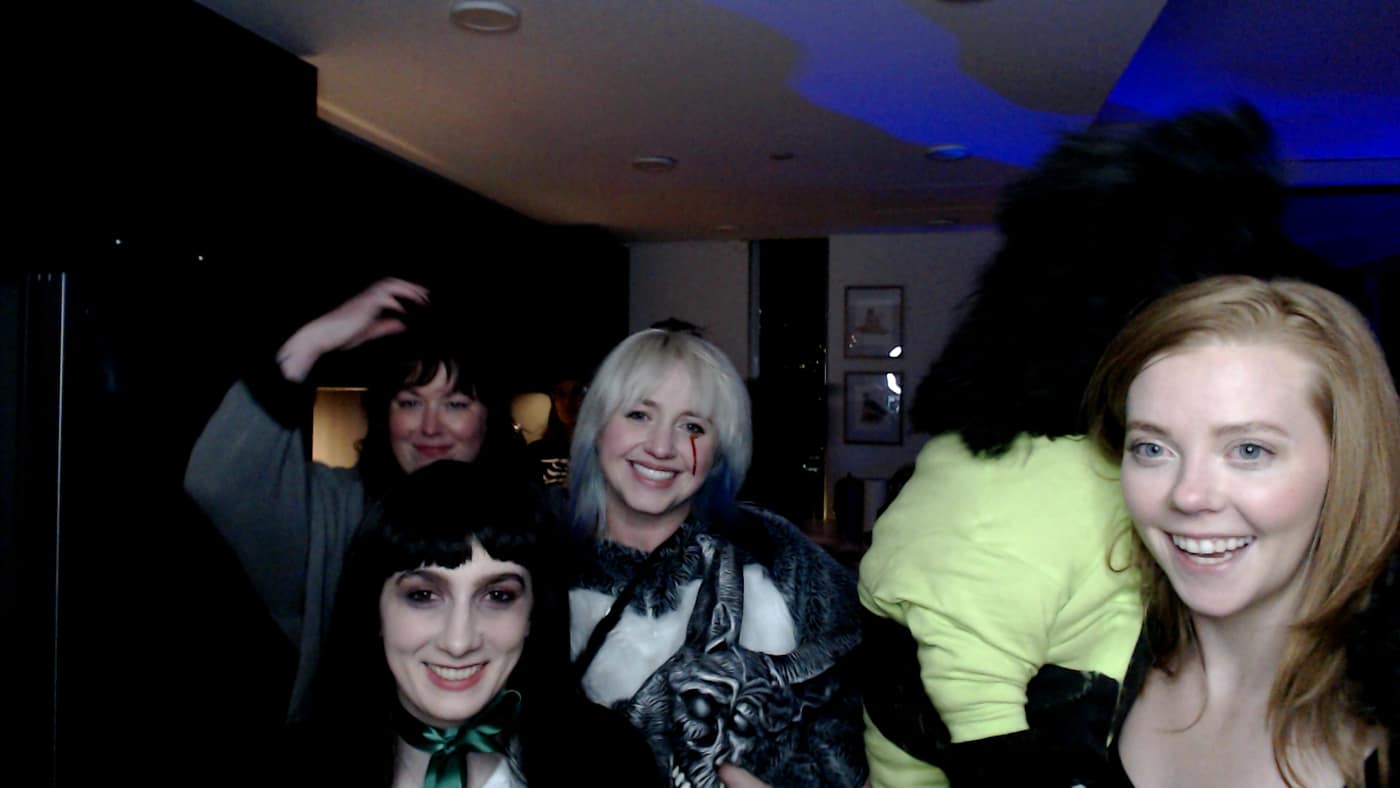 Guests posing at the photo booth during our 2023 Halloween party.