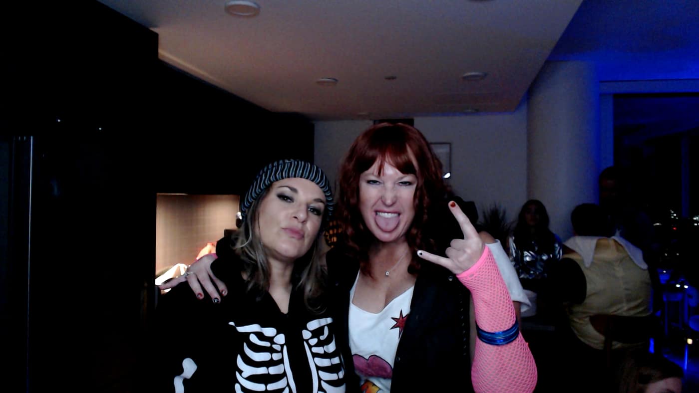 Guests posing at the photo booth during our 2023 Halloween party.