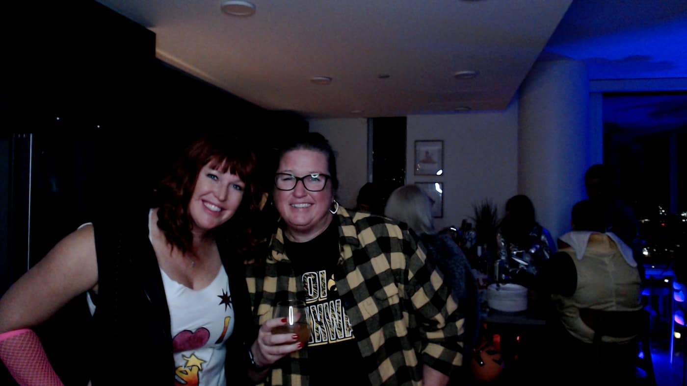Guests posing at the photo booth during our 2023 Halloween party.