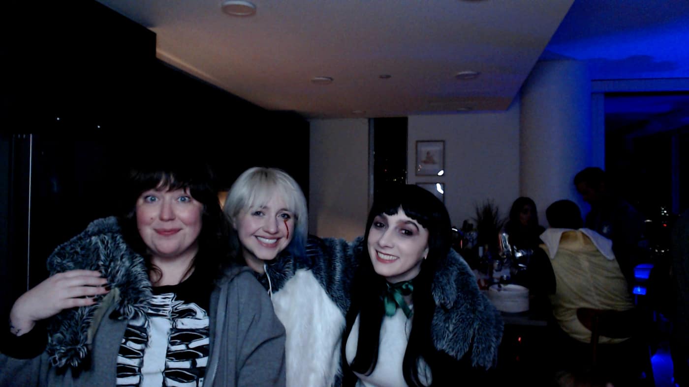 Guests posing at the photo booth during our 2023 Halloween party.