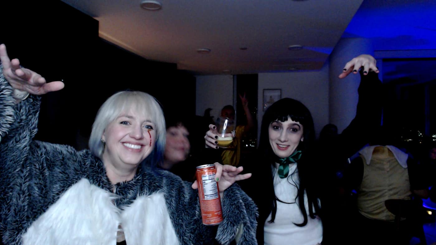 Guests posing at the photo booth during our 2023 Halloween party.