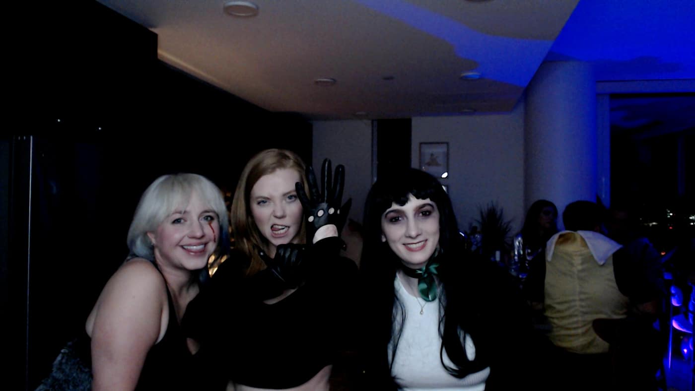 Guests posing at the photo booth during our 2023 Halloween party.