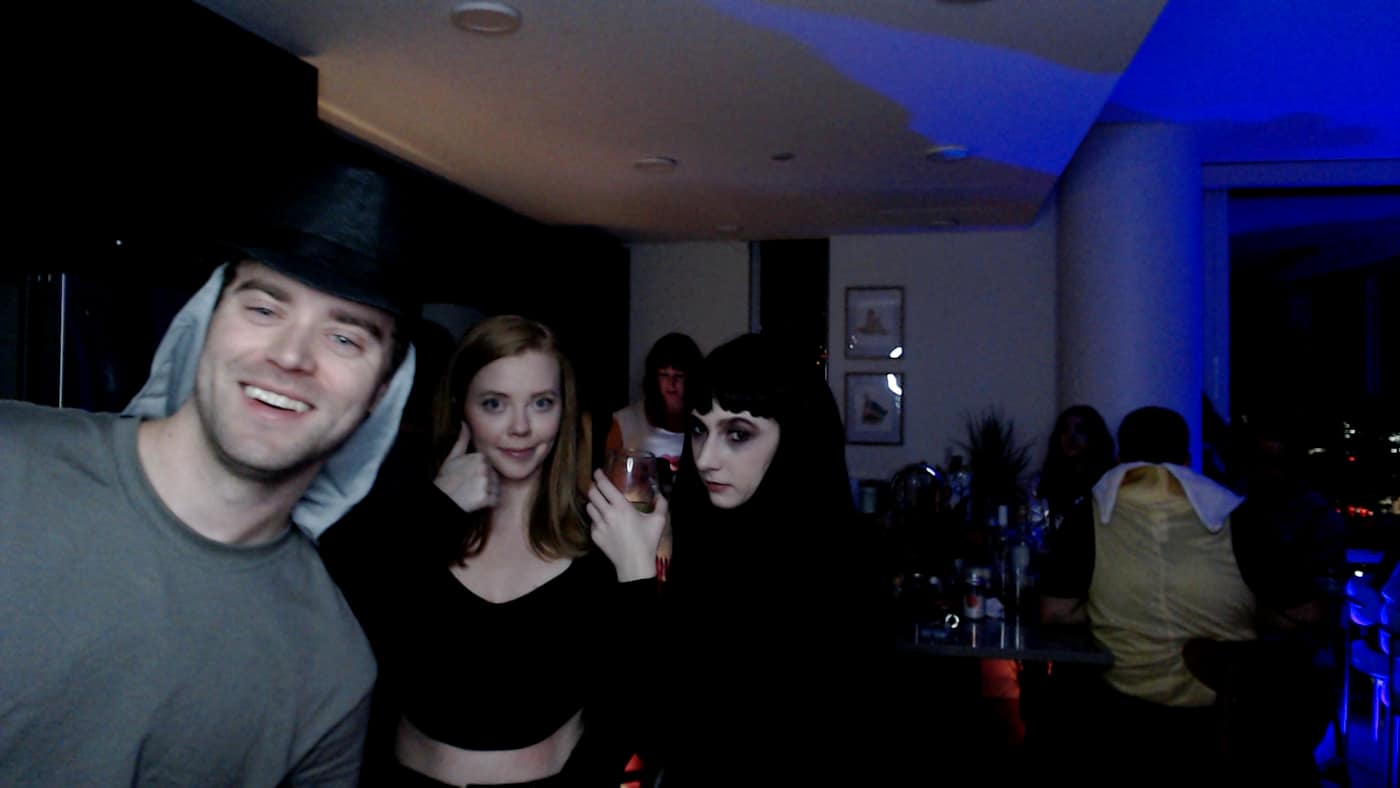 Guests posing at the photo booth during our 2023 Halloween party.