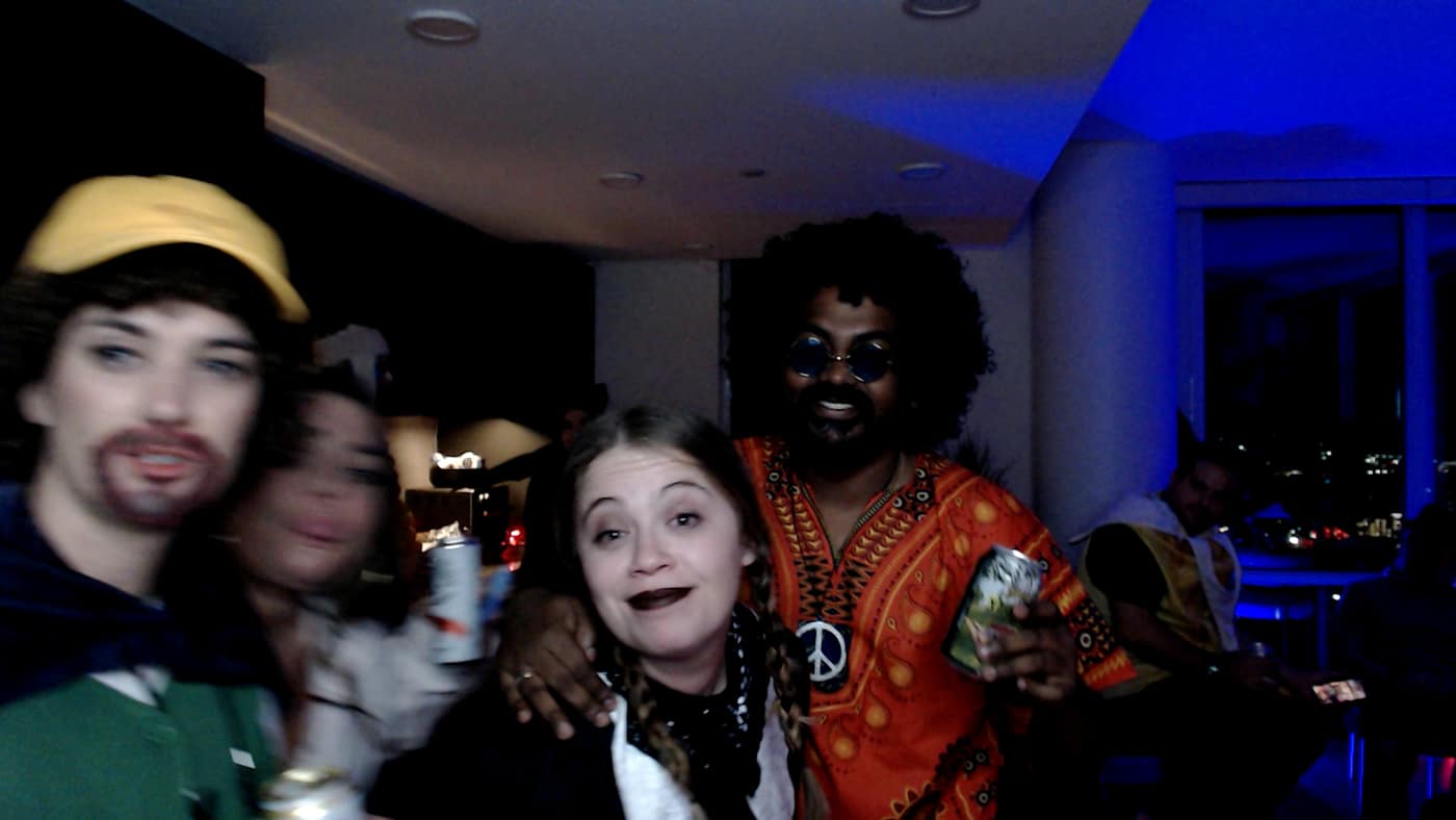 Guests posing at the photo booth during our 2023 Halloween party.