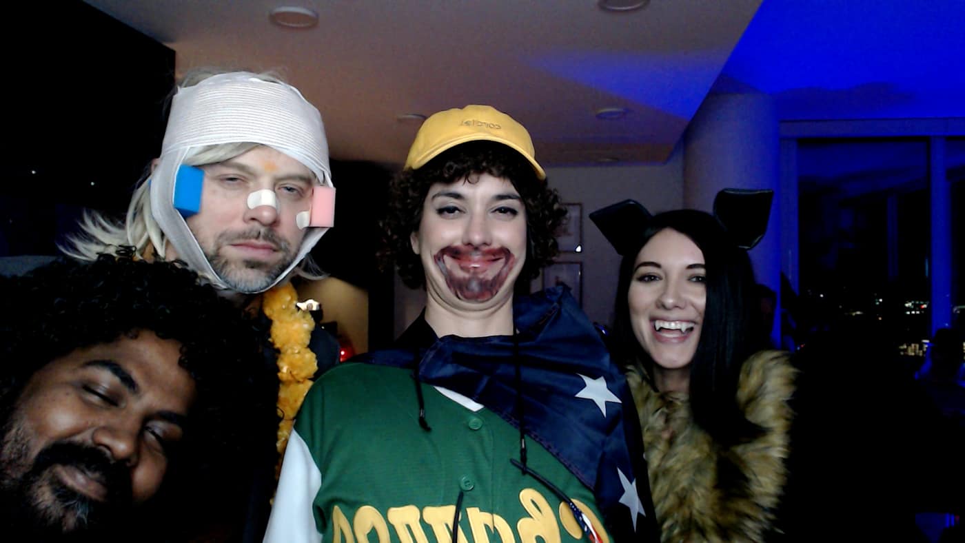 Guests posing at the photo booth during our 2023 Halloween party.