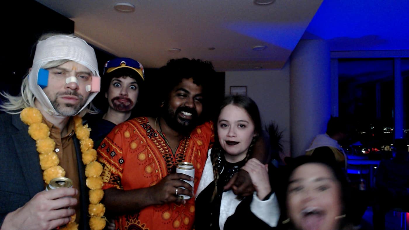 Guests posing at the photo booth during our 2023 Halloween party.