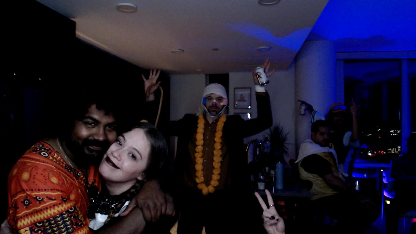Guests posing at the photo booth during our 2023 Halloween party.