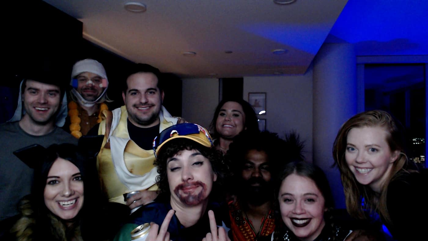 Guests posing at the photo booth during our 2023 Halloween party.